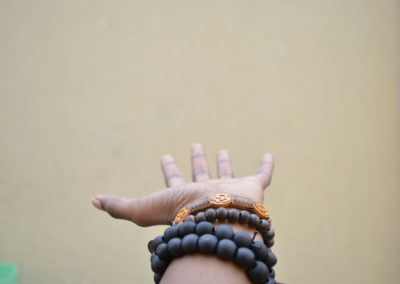 person hand with black beaded bracelets